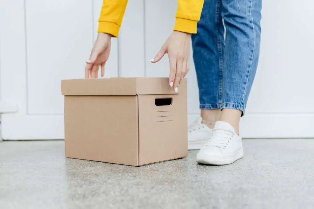 close-up-hands-lifting-box_23-2148767160