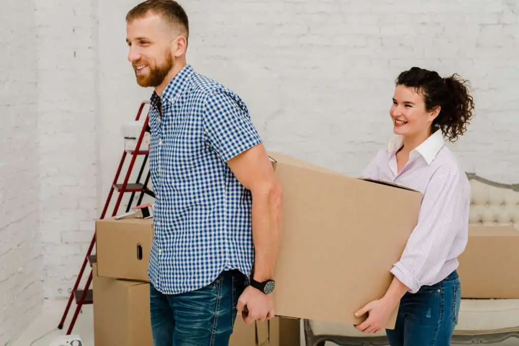 man-woman-carrying-box_23-2147758706