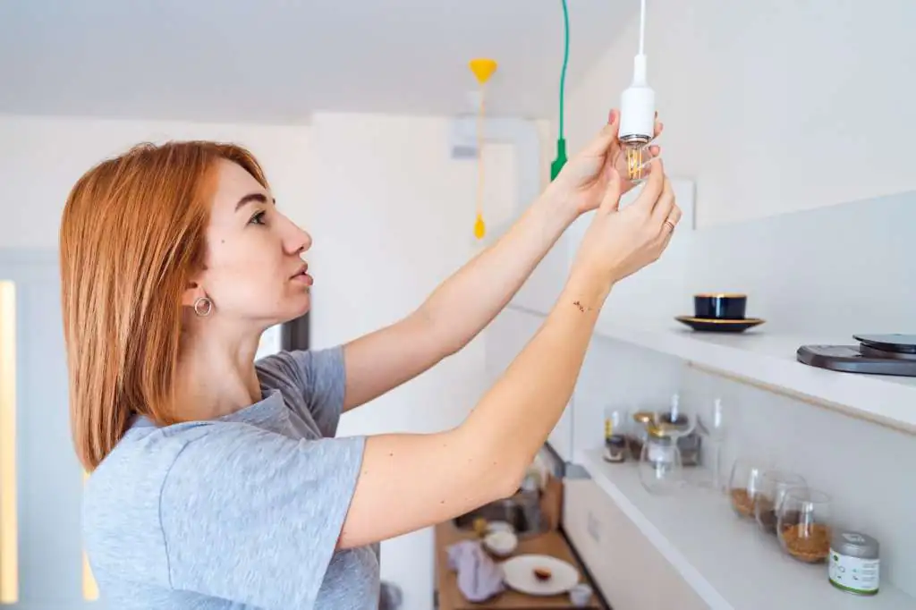 woman-unscrew-light-bulb_1153-3634