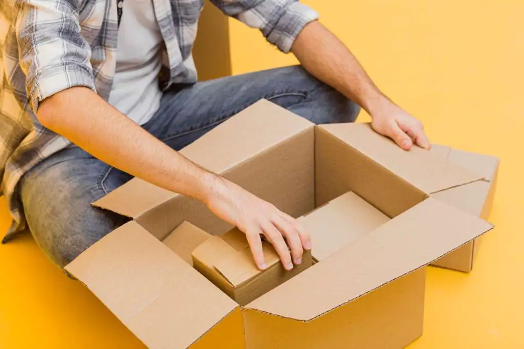How to Pack Boxes for Moving: The Ultimate Step-by-Step Guide-3 close-up-man-arranging-delivery-packages_23-2148447845