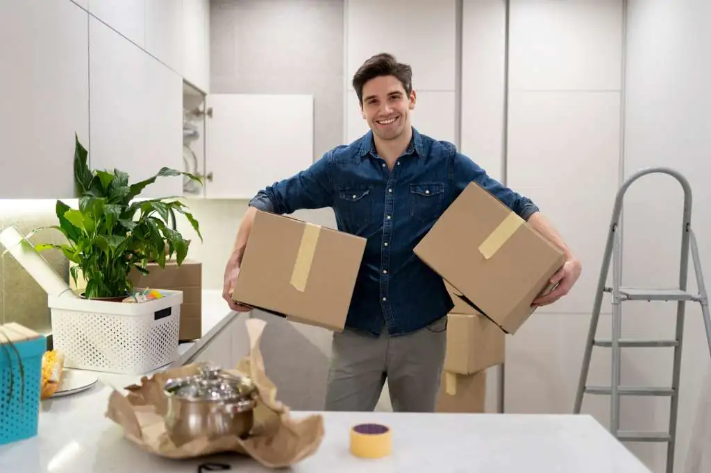 How to Pack a Kitchen for Moving: Step-by-Step Guide-4 man-handling-two-boxes-belongings_23-2149312721