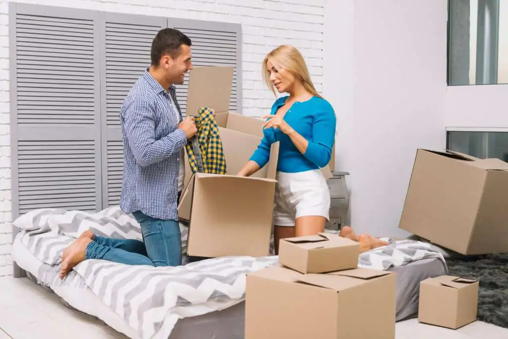 How to Pack a Mattress for Moving-3 man-woman-unpacking-boxes_23-2147694400