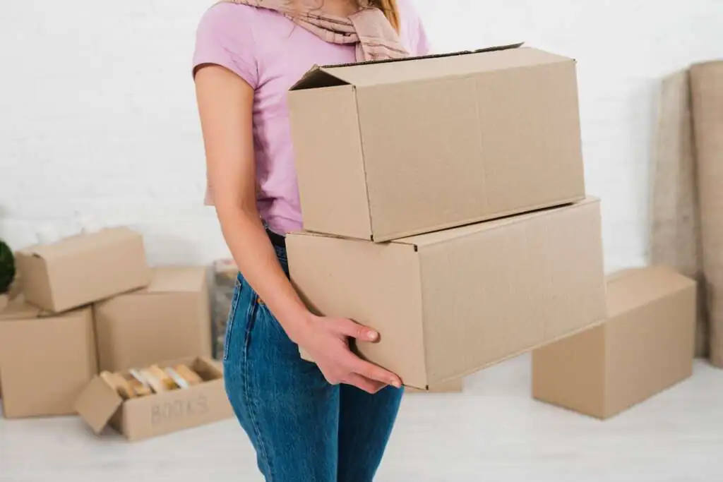 How to Pack Bathroom Items for Moving-3 mid-section-young-woman-holding-stack-cardboard-boxes_23-2148095519