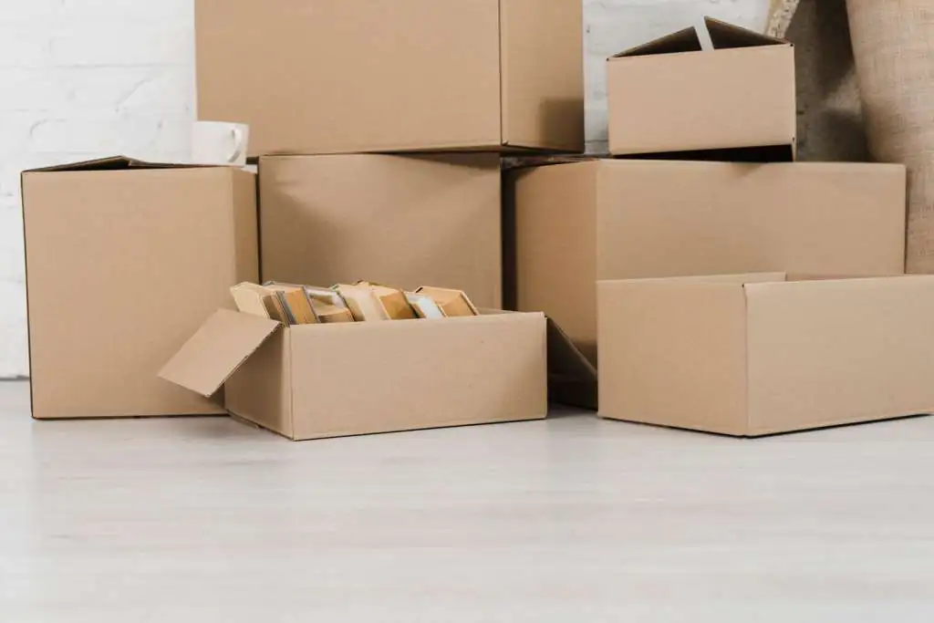 How to Pack a Pod for Moving: Step-by-Step-3 pile-cardboard-boxes-white-floor_23-2148095451